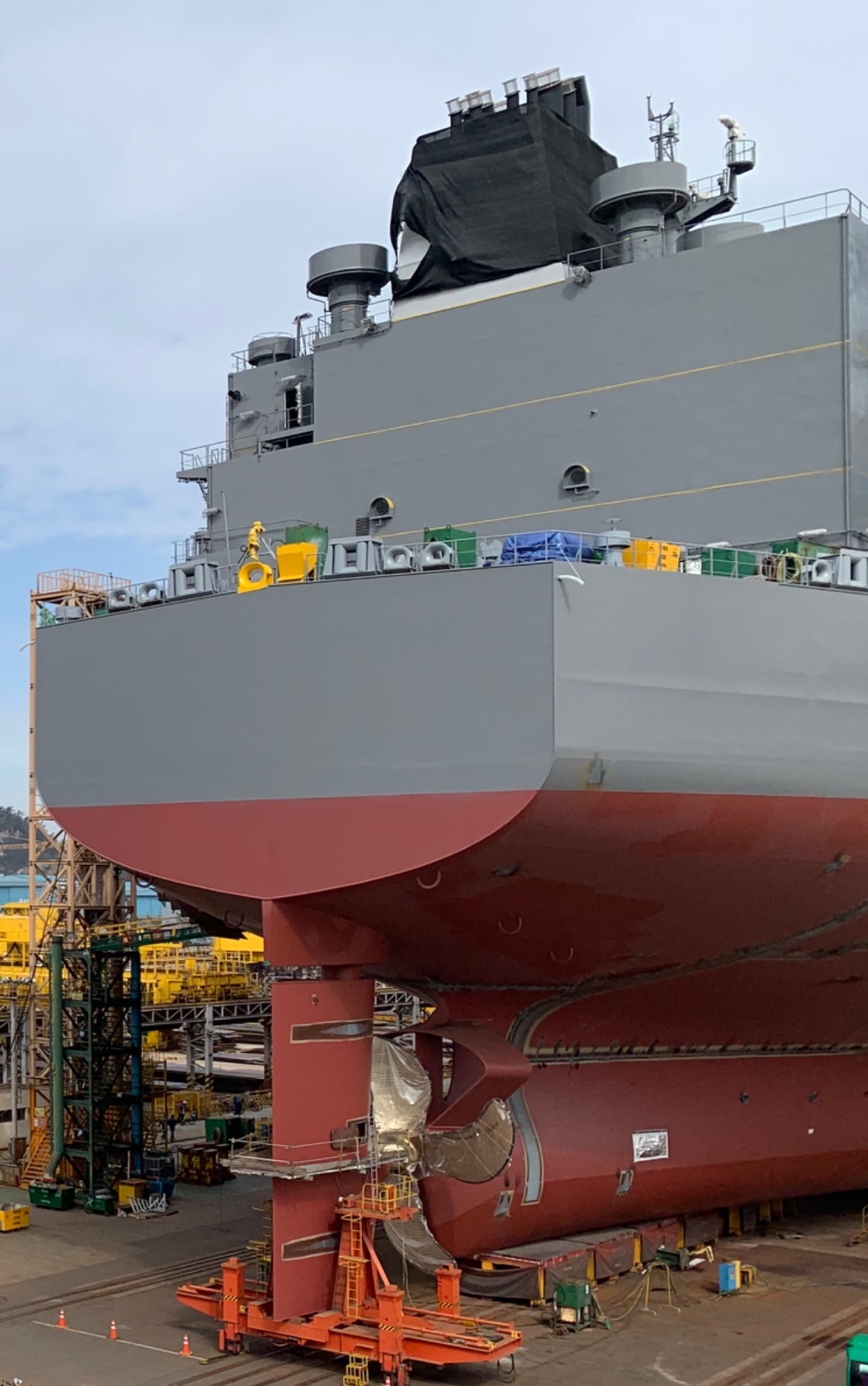 A ship under construction in a shipyard.